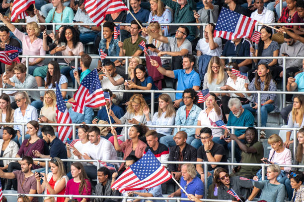istock People waving US flags on a stadium 1126182168