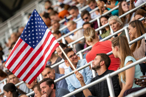 istock Man waving a US flag on a stadium 1126182199