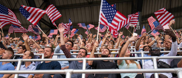 istock Fans waving USA flags and taking selfies 1126182213