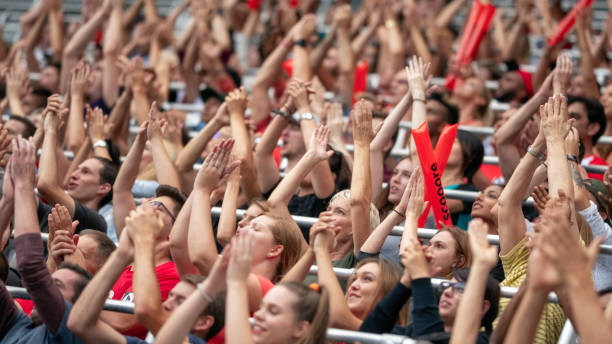 istock Crowd cheering for their team with arms raised 1126183820