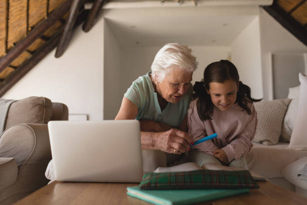 istock Grandmother helping her granddaughter with homework 1126184582