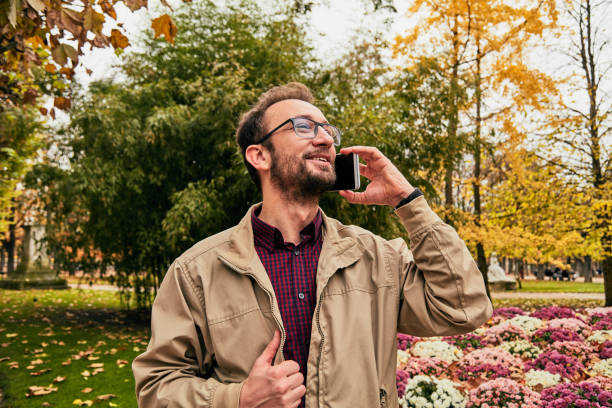 Modern man using cellphone in the European city.