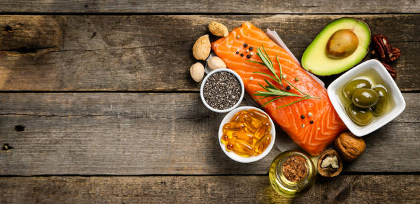Selection of healthy unsaturated fats, omega 3 Selection of healthy unsaturated fats, omega 3 - fish, avocado, olives, nuts and seeds fat nutrient stock pictures, royalty-free photos & images
