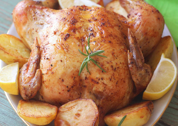 istock Whole roasted chicken with potatoes and lemon 1126189799