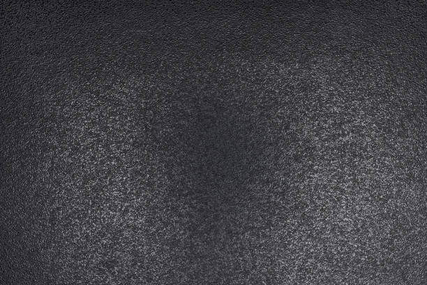 istock Closeup of black, rough background lit with dim light. 1126192158