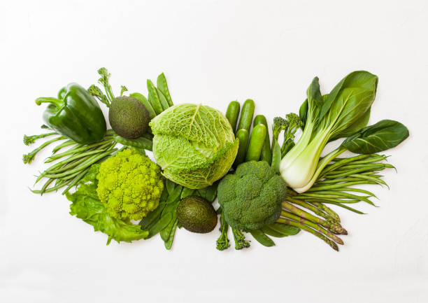 istock Assorted green toned raw organic vegetables on white background. Avocado, cabbage, broccoli, cauliflower and cucumber with trimmed and mung beans, pak choi, loose pepper and lettuce. Green energy 1126192318