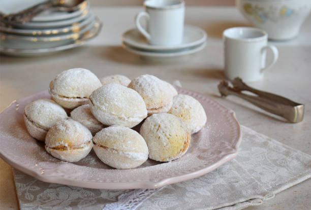 istock Walnut shaped cookies with cream. Shortbread with caramel and walnuts stuffing. Russian or ukrainian sweets oreshki.  Copy Space. 1126192615