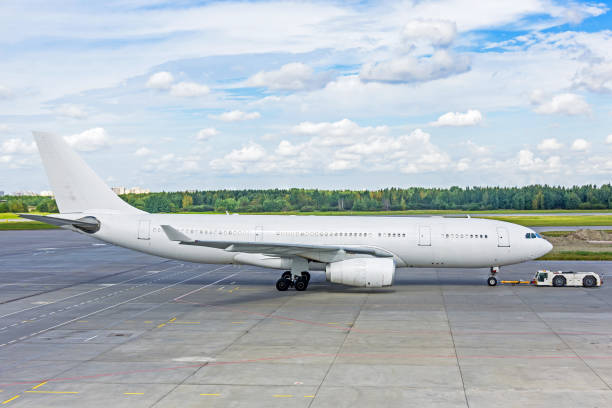istock White painted passenger jet airplane pushed back from the parking. 1126198131