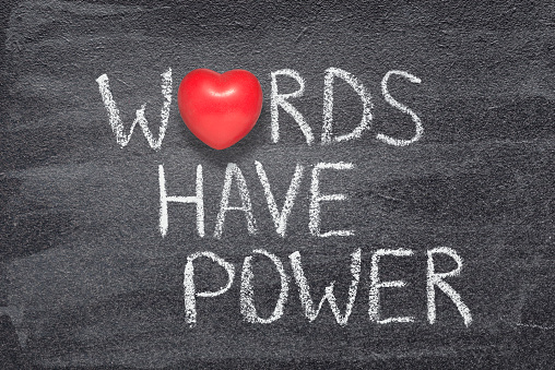 words have power phrase written on chalkboard with red heart symbol instead of O