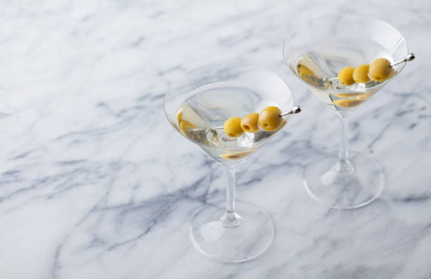 istock Martini cocktail with green olives on marble table background. Copy space. 1126203187