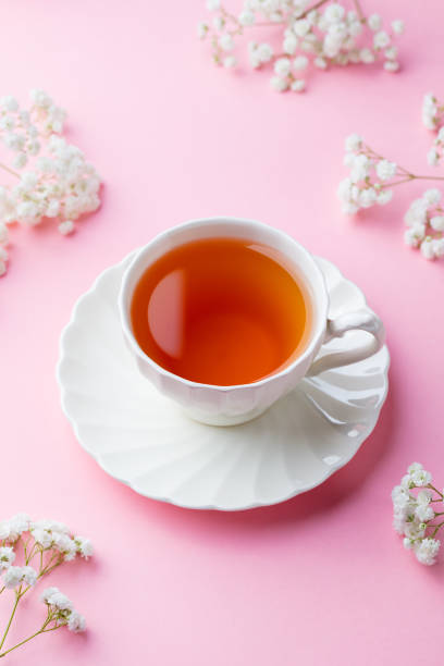 istock Cup of tea with fresh flowers on pink background. Copy space. 1126204375