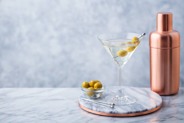 istock Martini cocktail with olives and bar shaker on marble table background. Copy space. 1126204548