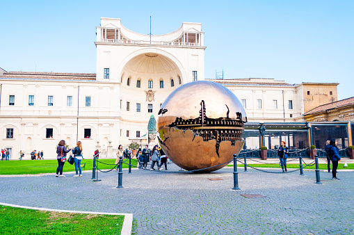 Vatican, Rome, Italy - November 16, 2018: Sphere Within Sphere Sfera con sfera is a bronze sculpture by Italian sculptor Arnaldo Pomodoro decorates a center of the Cortile della Pigna in Vatican