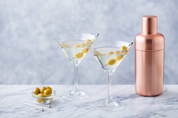 istock Martini cocktail with olives and bar shaker on marble table background. Copy space 1126205019