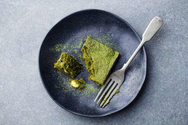 istock Matcha green tea cake, bars, brownie with white chocolate on a plate. Grey background. Top view. 1126205270