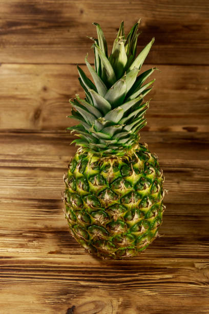 istock Whole pineapple on wooden table 1126205616
