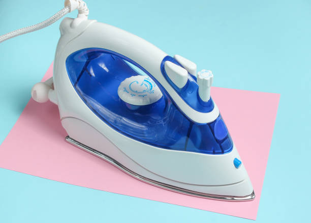 istock Iron for ironing on a colored pastel background, top view. Minimalism 1126206012