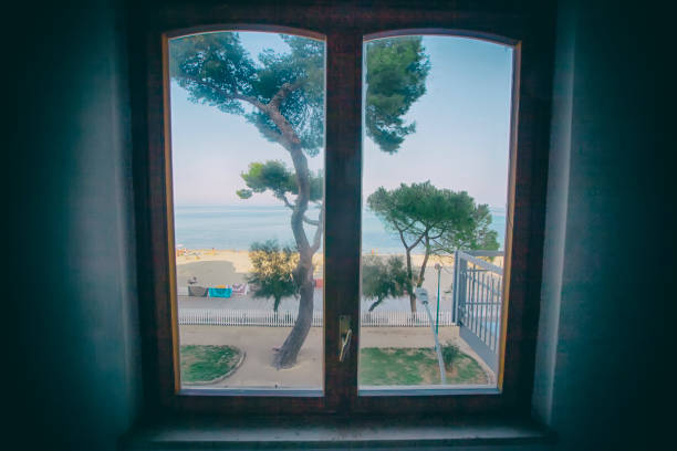 istock View of the beach in Sicily through the window 1126211725