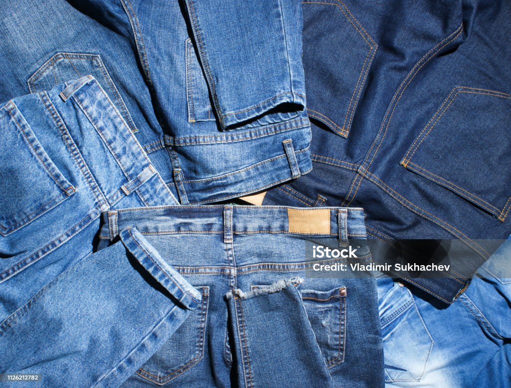 Background of many jeans pants Jeans Stock Photo