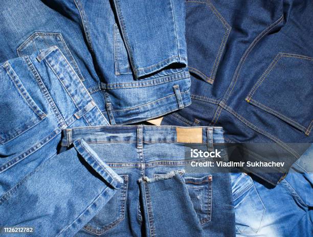 Background Of Many Jeans Pants Stock Photo - Download Image Now - Jeans, Denim, Pants