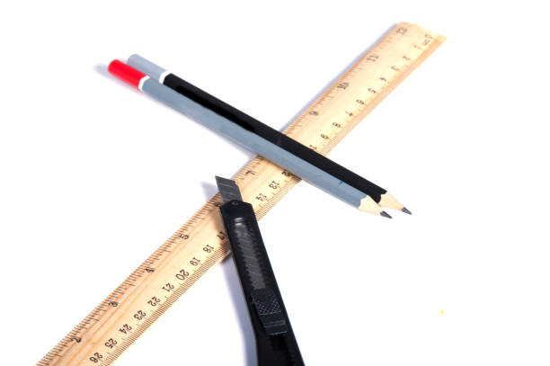 istock ruler with two pencils and a puzzle on a wooden background. 1126215236