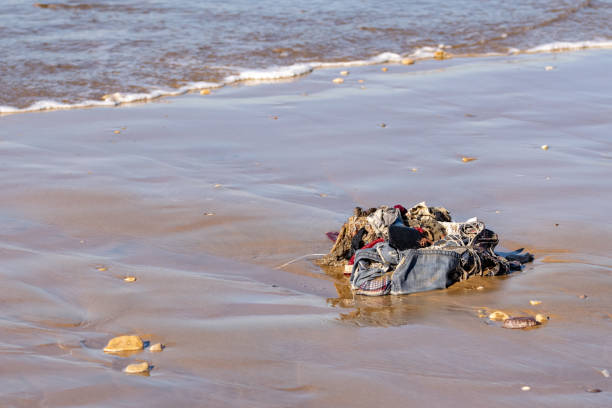 rubbish, clothing and household belongings washed up from the atlantic ocean on agadir beach, morocco, africa - toxic substance spilling pouring bottle imagens e fotografias de stock