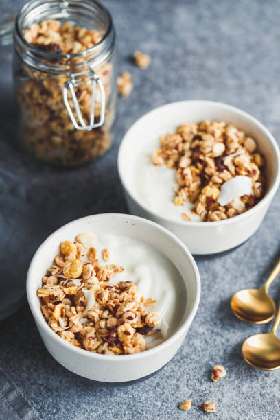 istock Breakfast bowl with organic granola, nuts, coconut chips and greek yoghurt. 1126216570