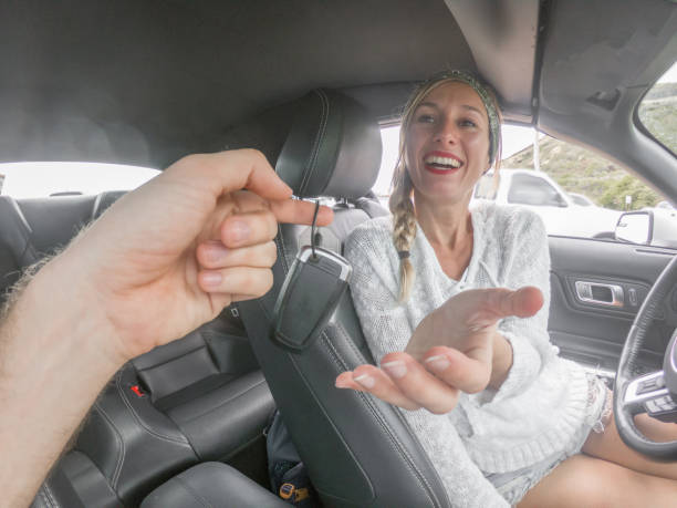 istock Excited young driver female inside car accepts car keys 1126222476