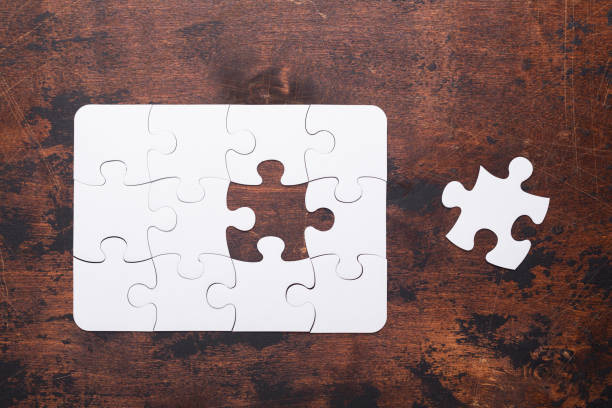 istock Jigsaw Puzzle with missing piece on old wooden background Top view 1126227318