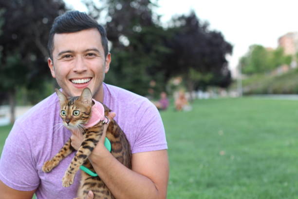 istock Handsome man in the park with his cat 1126232713