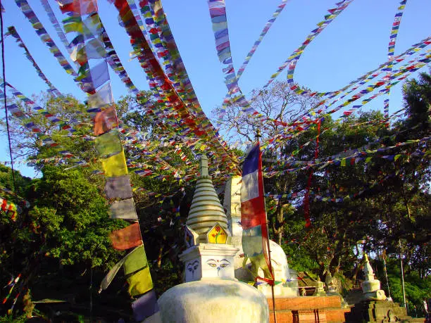 Photo of Small stupa with colorful Buddhist flags of Swayambhunath temple complex. Kathmandu, Nepal.