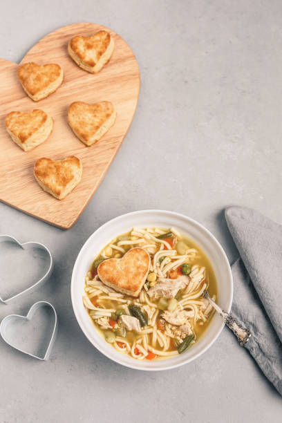 istock Heart-Shaped Biscuits with Homemade Chicken Soup on Gray Background 1126237355