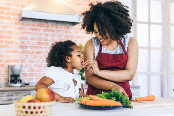 istock Mother gives a carrot to child 1126237524