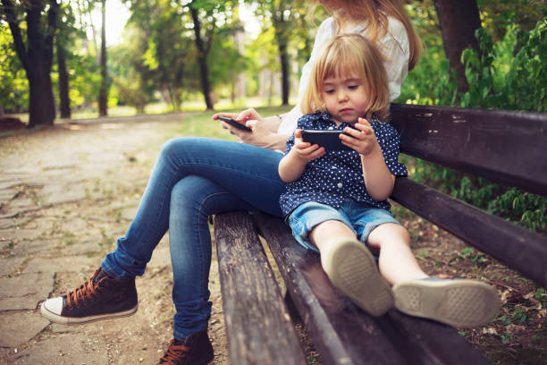 istock Little child and his mom using smart phones 1126248282