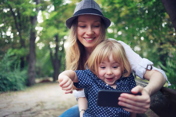 istock Little child and his mom using smart phone 1126248288
