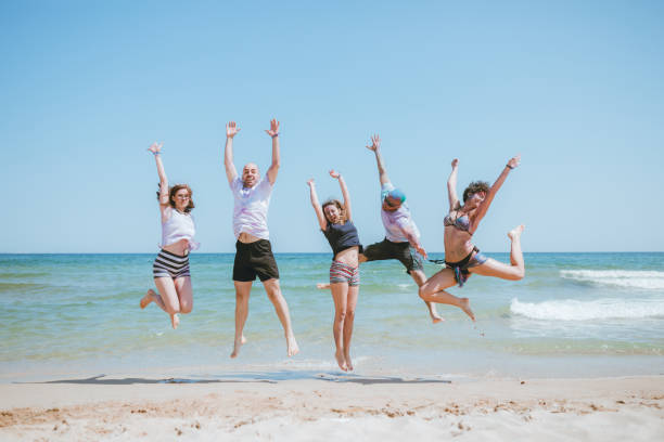 istock Jump of joy at the beach 1126249863
