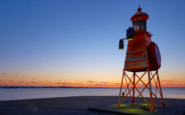 istock Ligthhouse in the sunset 1126250671
