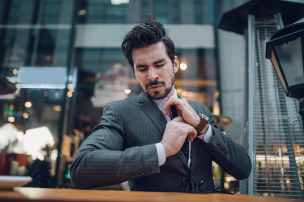 istock Serious young businessman, holding his necktie 1126252148