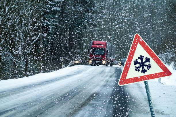 Snowy curvy road with traffic sign stock photo