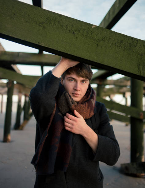 istock Portrait of young man in coat looking at camera 1126255502
