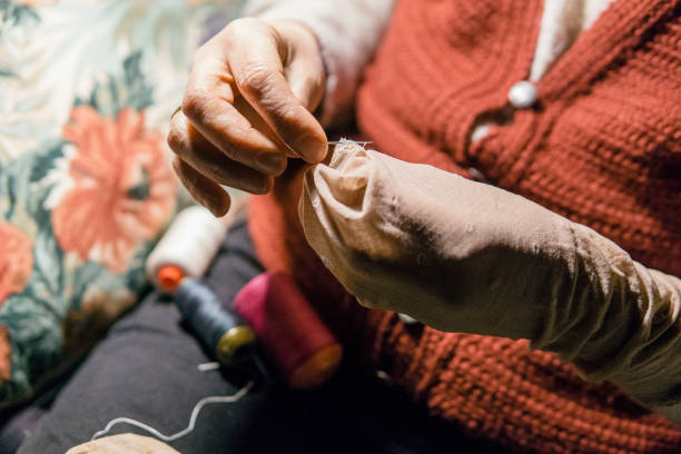 istock Senior woman sewing at home 1126255644