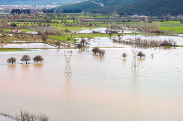 View of a flooded field on farmland with electrical transformers