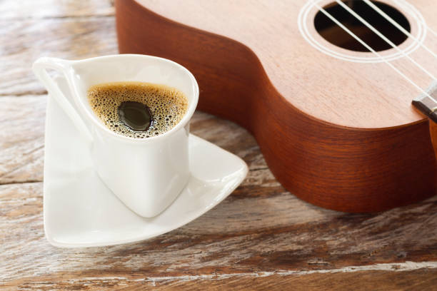 istock cup of coffee and ukulele on rustic wood 1126265913
