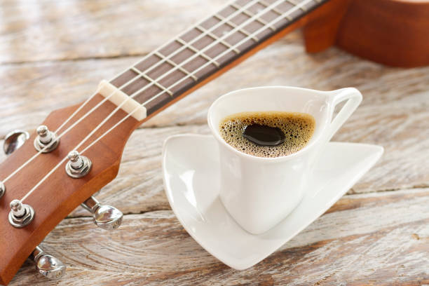 istock cup of coffee and ukulele on rustic wood 1126265967
