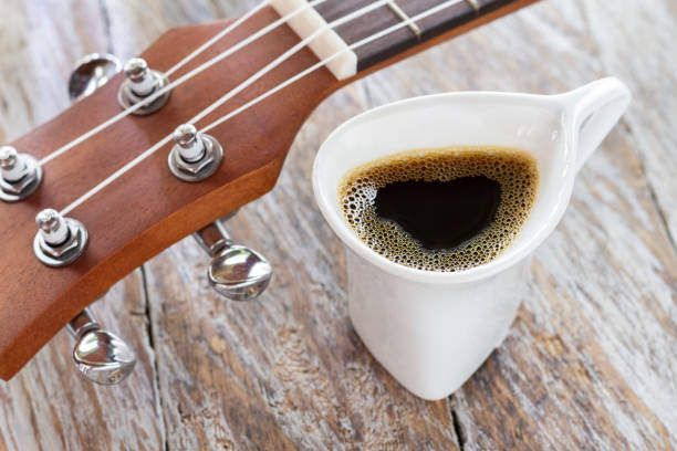 istock cup of coffee and ukulele on rustic wood 1126266385