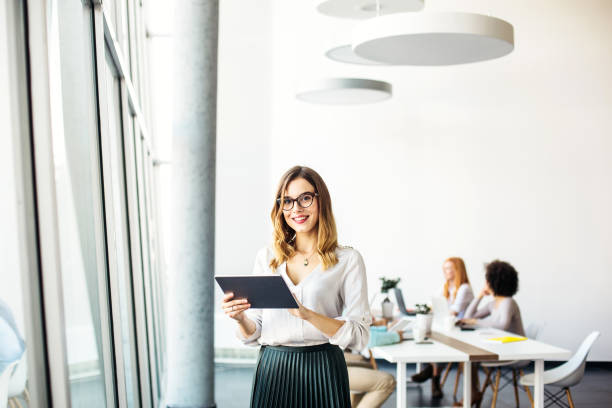 istock Young businesswoman using tablet in the office 1126270053
