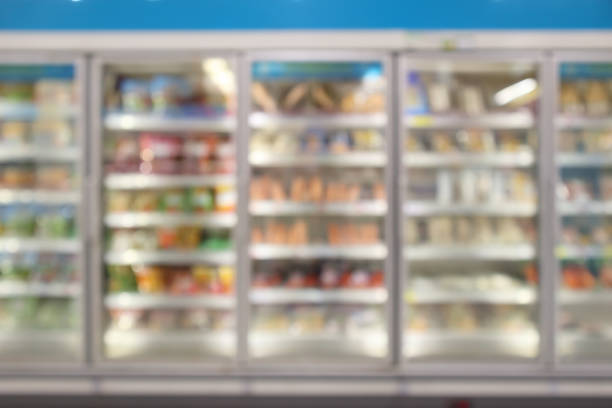 supermarket commercial refrigerators freezer showing frozen foods abstract blur background supermarket commercial refrigerators freezer showing frozen foods abstract blur background frozen food stock pictures, royalty-free photos & images