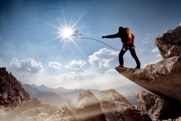 istock Man throws rope to rappelled off a mountain top 1126277367