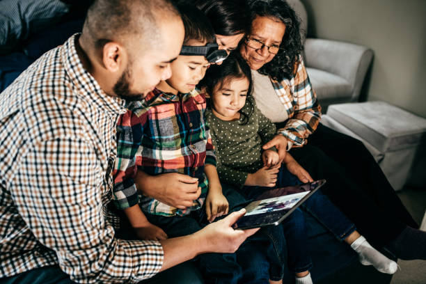 istock FAmily with tablet reading books 1126278378