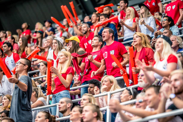 istock Crowd cheering for their team with arms raised 1126295335